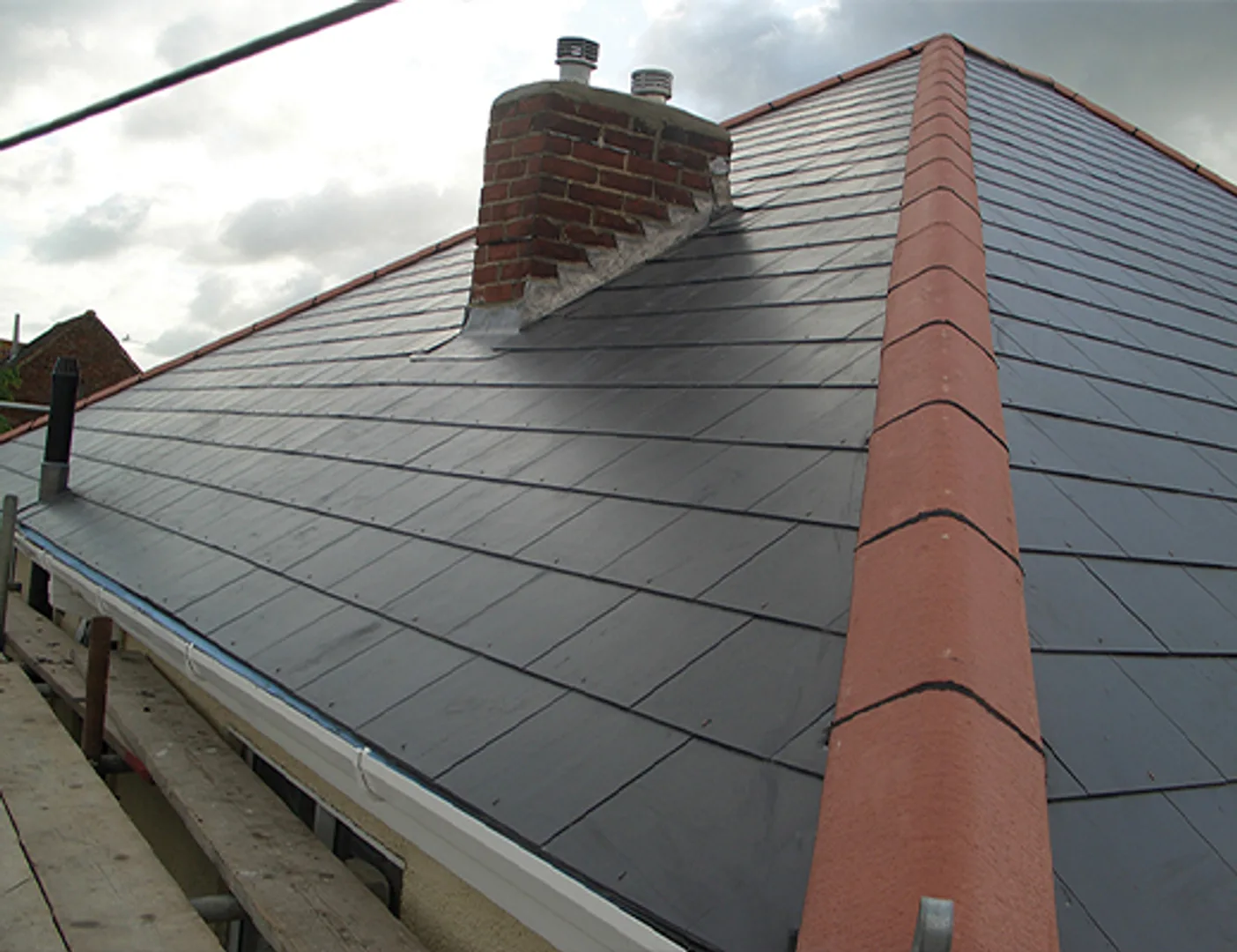 Slate roof tiles around a chimney